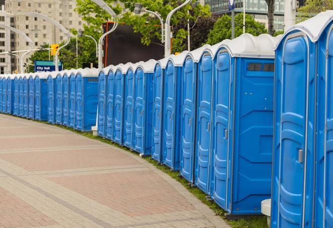 a row of portable restrooms set up for a large athletic event, allowing participants and spectators to easily take care of their needs in Trophy Club TX